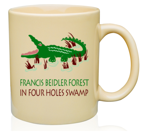Beige mug with a bright green alligator graphic around brown cypress knees. The mouth of the alligator is open and below the graphic reads: Francis Beidler Forest / Four Holes Swamp 