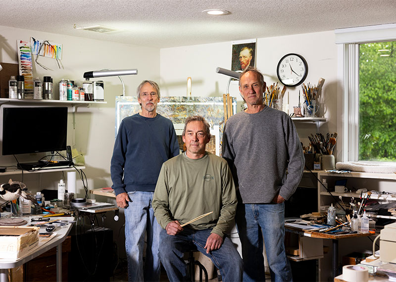 Joe, Jim, and Bob Hautman pose in Jim’s home studio. Together they have produced 15 winning duck stamps.
