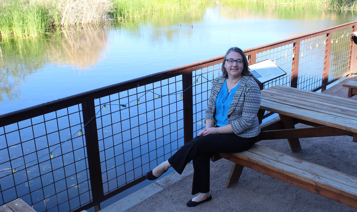 Our executive director, Sonia Perillo, sits at the pond with a bittersweet smile.