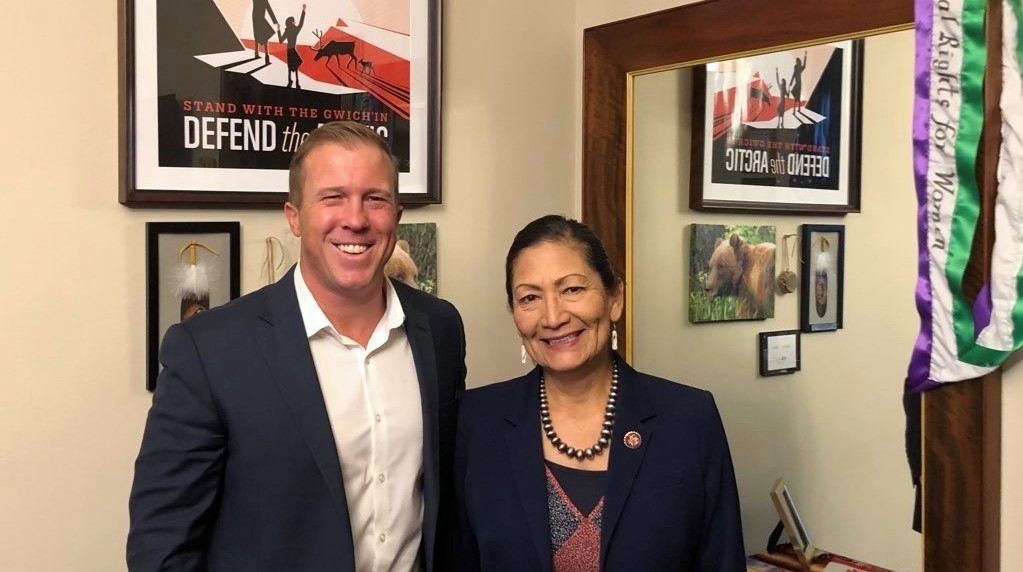 Audubon Southwest's executive director Jon Hayes standing with Representative Deb Haaland in her office, both smiling.