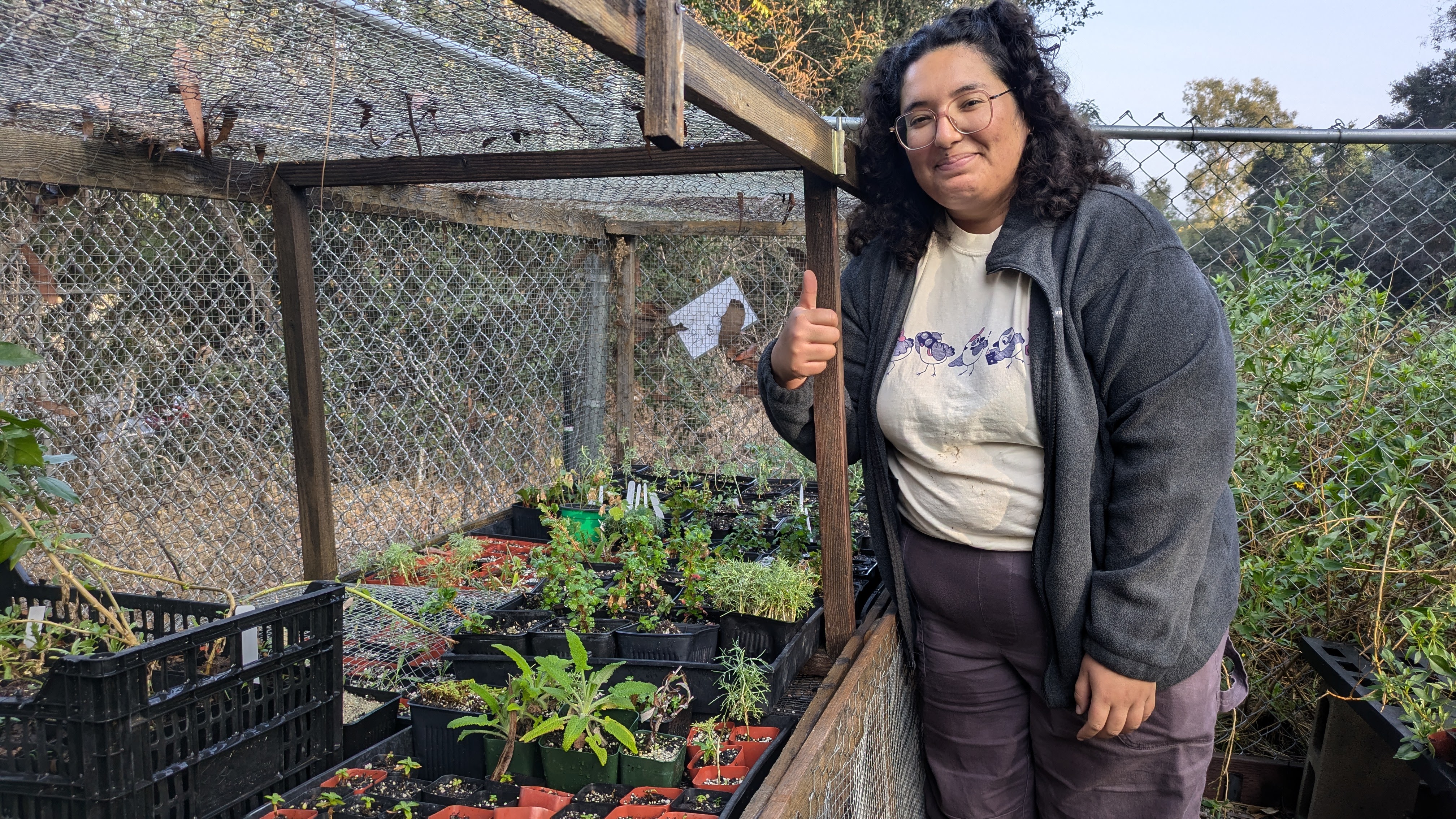 Amaris poses next to a cage down at the Los Nogales Nursery.