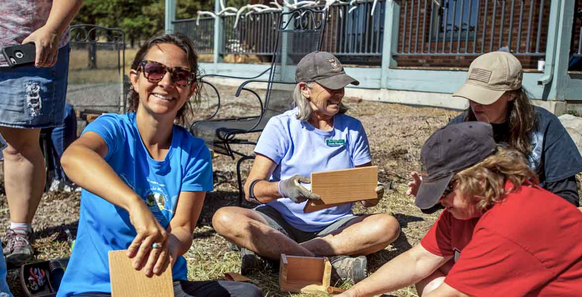 Jamie Weiss builds a birdhouse at a garden planting.