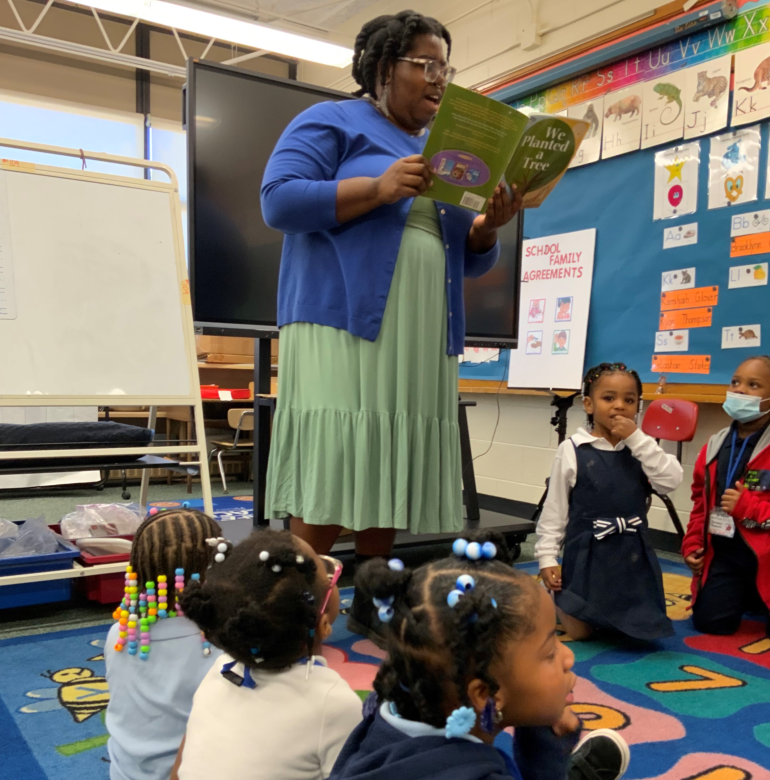 Jennifer Johnson, Audubon's Wild Indigo Program Associate read the story, “We Planted a Tree,” by Diane Muldrow, and facilitated discussions with the classes about the structure and makeup of a tree.. Photo: Bethune Early Childhood Development Center