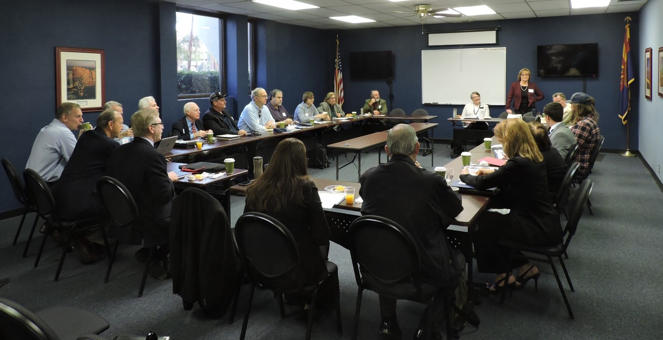 Around a table, a group of birders, hunters, anglers, brewers, and more, sit with Audubon and policy makers in Arizona. 