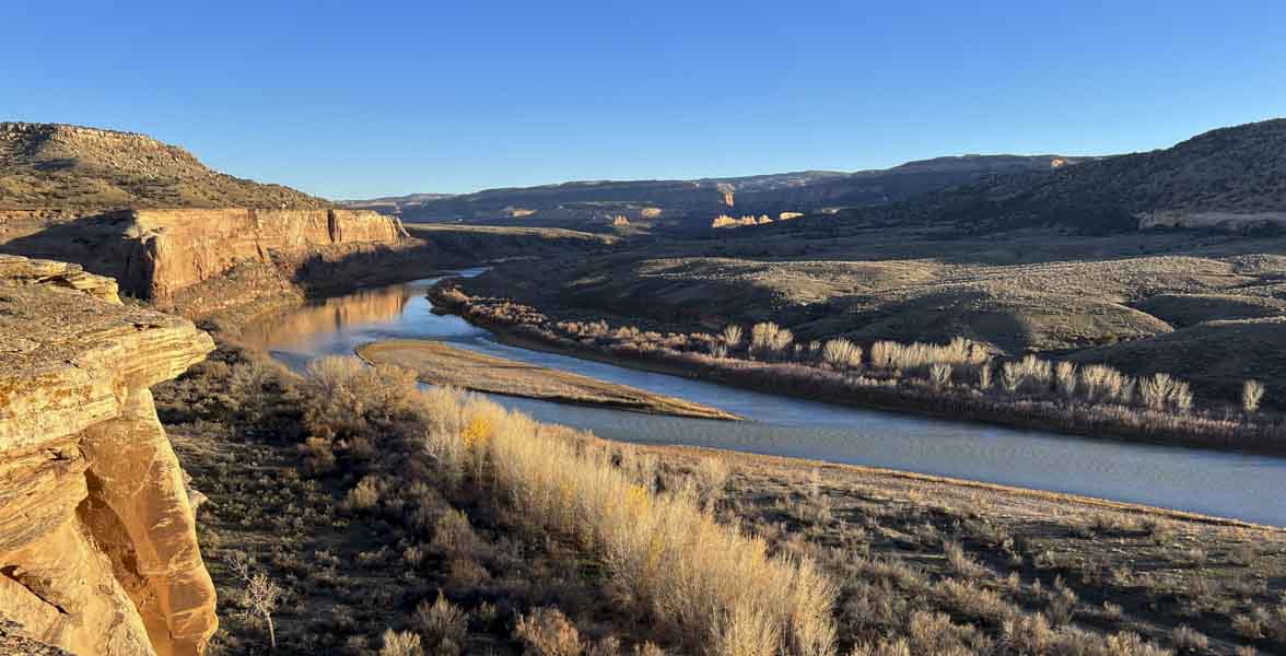 A river flows through a dry landscape.