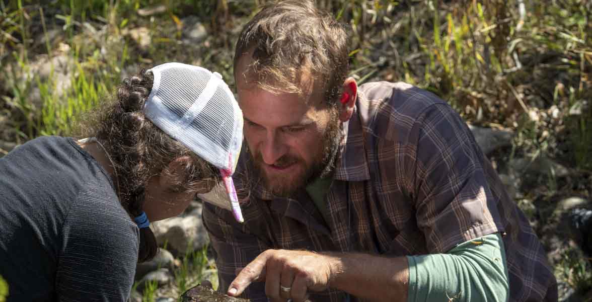 Keith Bruno pointing out a finding to a student.