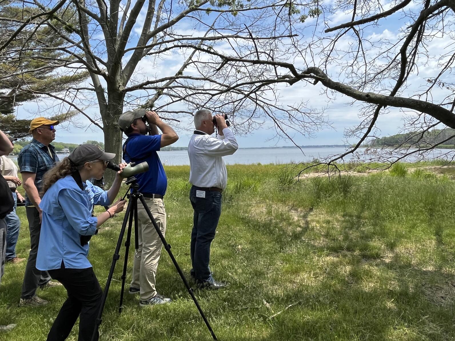 Sen. Jon Bumstead (R-MI-34) looks through binoculars with while birding with Audubon Great Lakes and partners