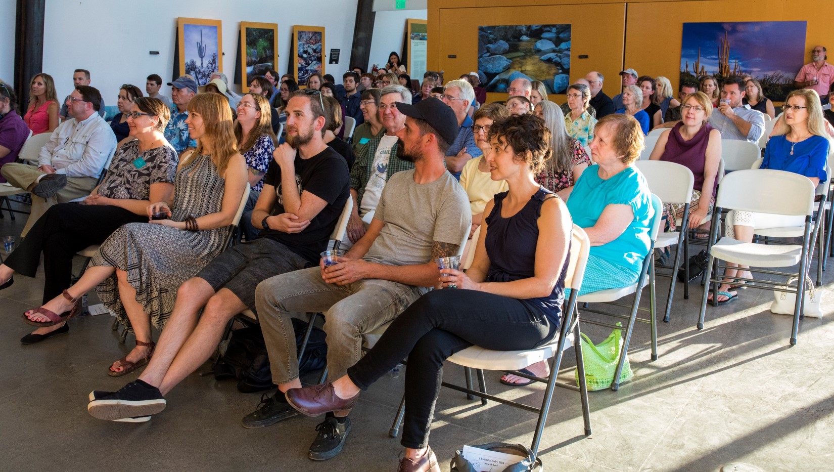 An audience sits in the nature center.