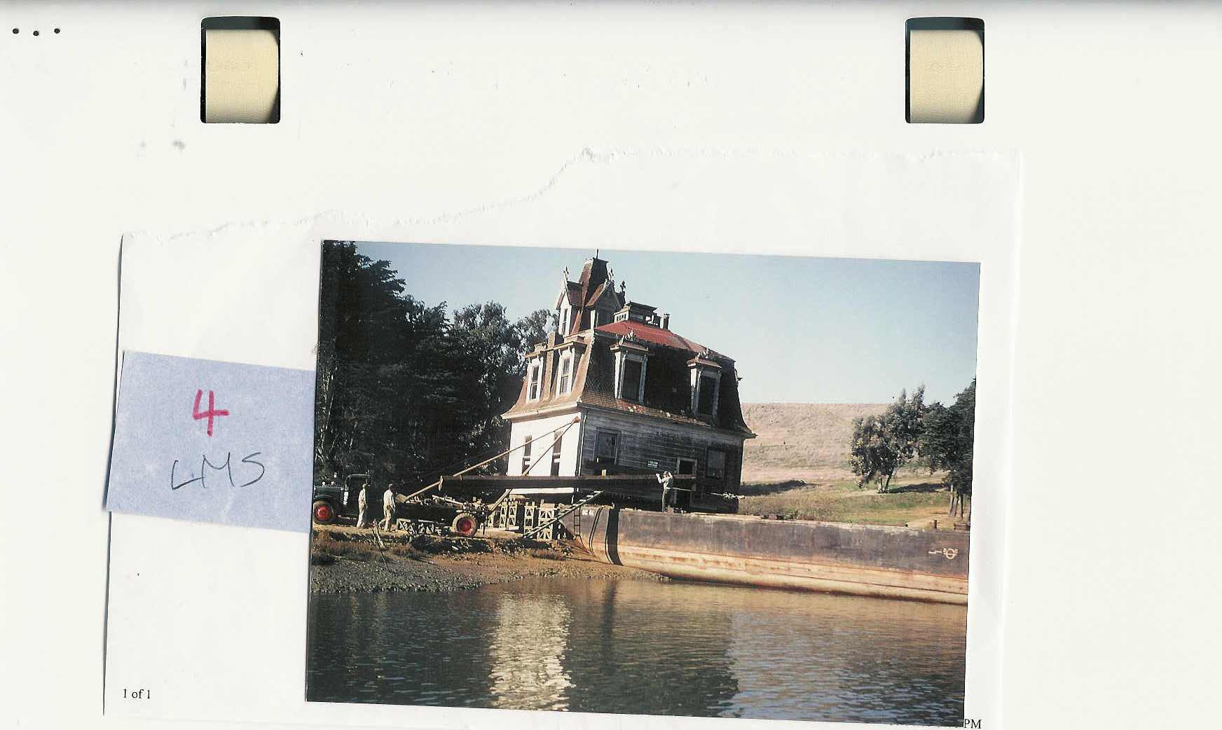 A scanned copy of a photograph of the Lyford House being winched into place at Richardson Bay.