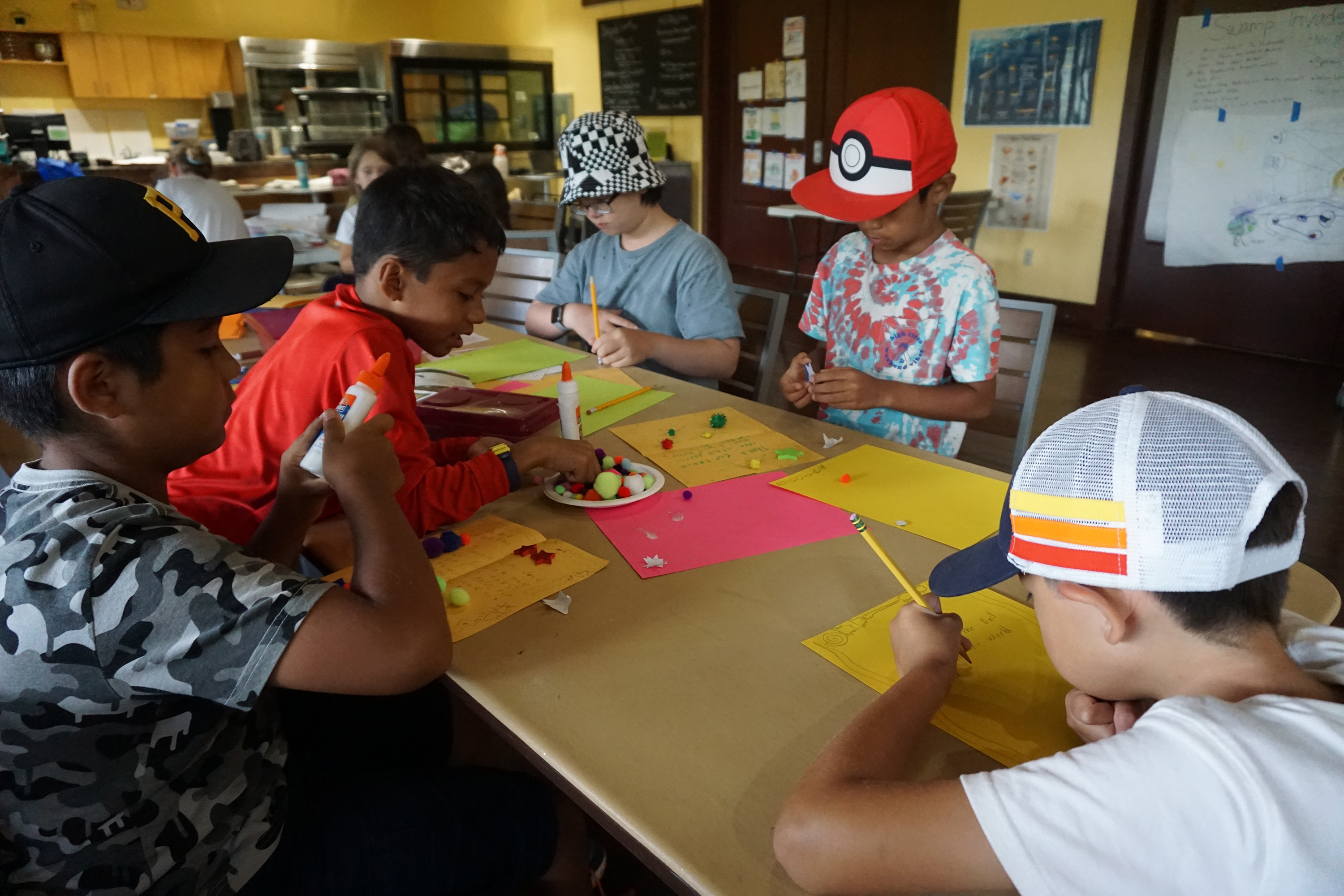 Campers enjoying crafts indoors