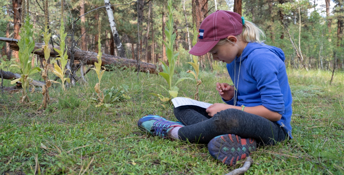 A fourth-grade student participates in an activity during a field trip.